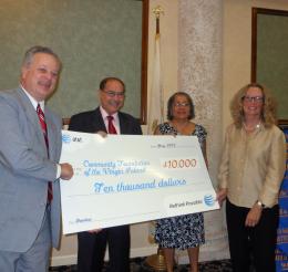 AT&T regional vice president, Ray Flores, second from left, presents a $10,000 check to Community Foundation president, Dee Bacher-Brown, right, as Rotarians Tom Bolt and Beverly Chongasing look on.